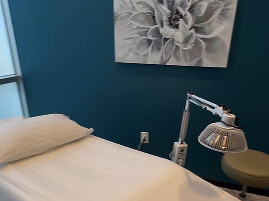 Acupuncture treatment room at AZ Fertility Acupuncture in Gilbert, Arizona, with a made-up treatment table and natural light