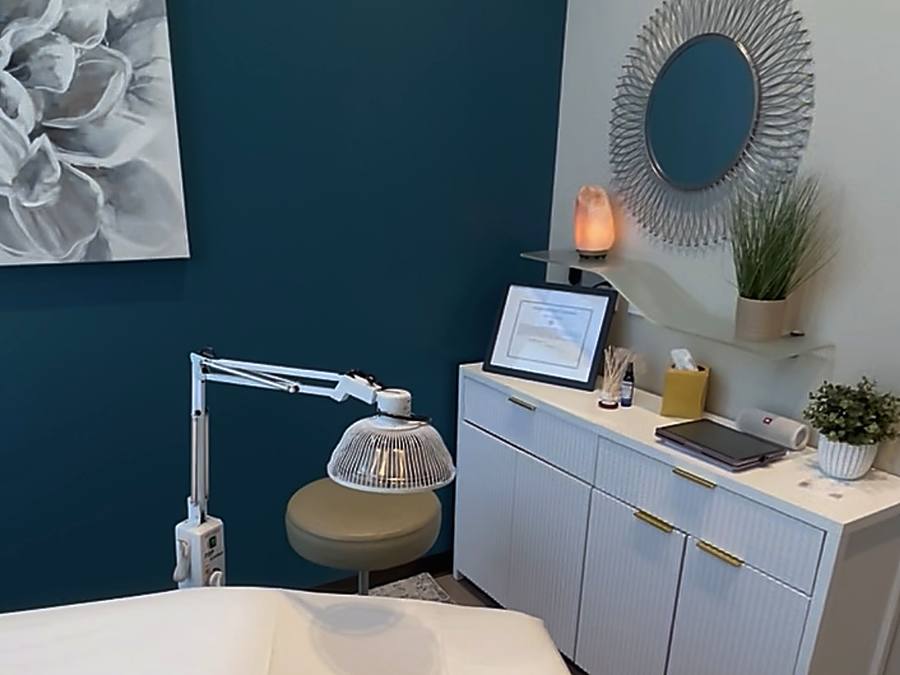 Treatment room at AZ Fertility Acupuncture in Gilbert, Arizona, with heat lamp, salt lamp and Amie Guerra&rsquo;s acupuncture credentials on display